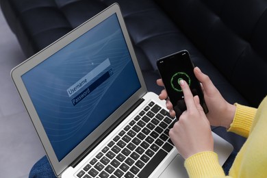 Photo of Woman unlocking smartphone with fingerprint scanner, closeup. Her laptop password protected to