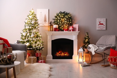 Stylish living room interior with beautiful fireplace, Christmas tree