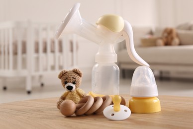 Photo of Baby care stuff on wooden table indoors. Maternity leave concept