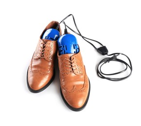 Pair of stylish shoes with modern electric footwear dryer on white background