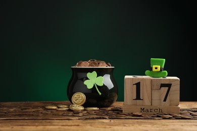 Photo of Composition with block calendar on wooden table. St. Patrick's Day celebration