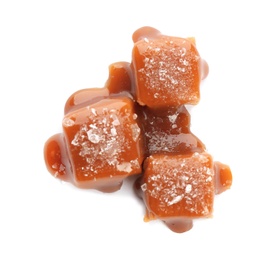 Photo of Delicious candies with caramel sauce and salt on white background, top view