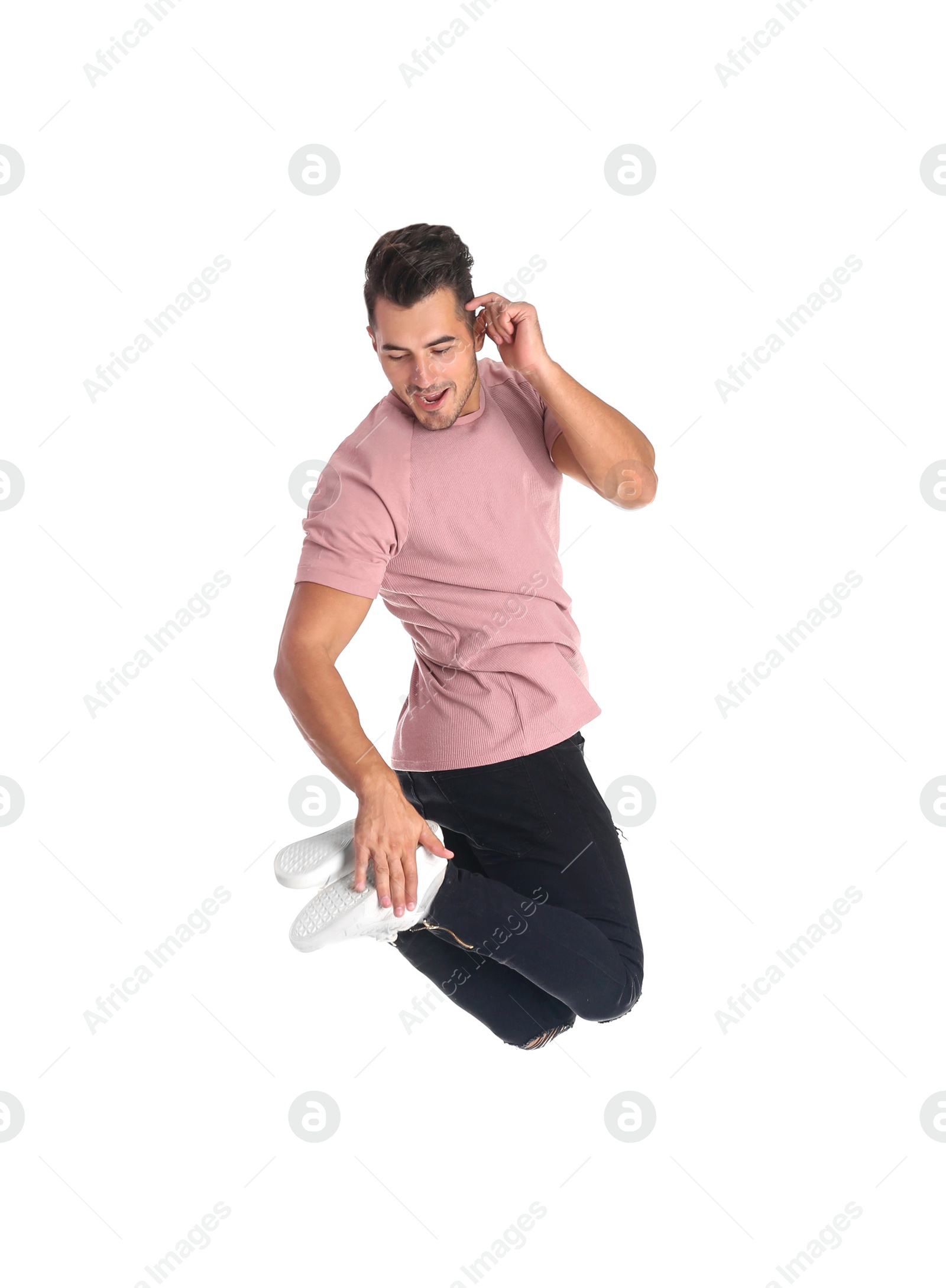 Photo of Young man in stylish jeans jumping on white background