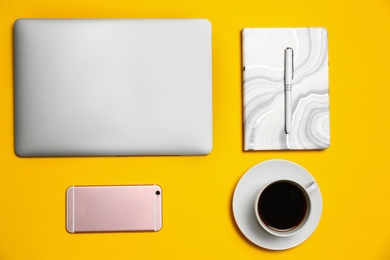 Photo of Flat lay composition with modern laptop on yellow background