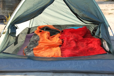 Photo of Camping tent with sleeping bags in wilderness