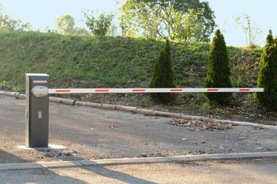 Photo of Closed boom barrier on sunny day outdoors
