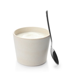 Photo of Bowl with spoon and yummy yogurt on white background