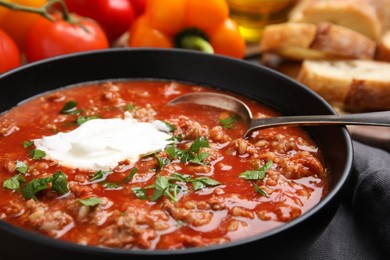 Photo of Bowl of delicious stuffed pepper soup, closeup view