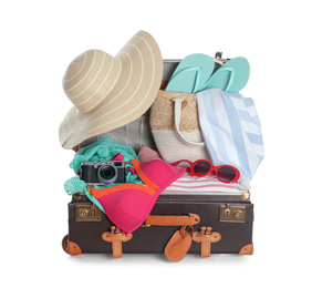 Photo of Open vintage suitcase with different beach objects packed for summer vacation isolated on white