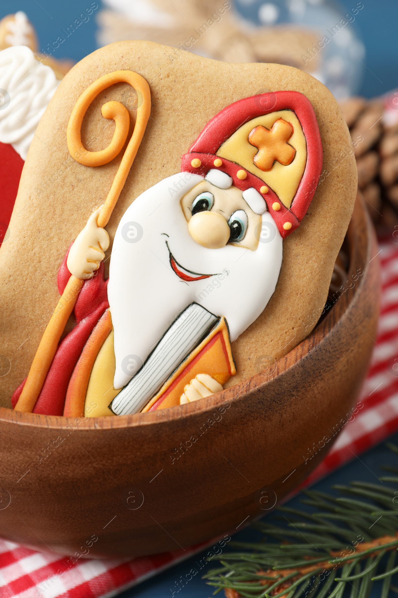 Photo of Tasty gingerbread cookie on table, closeup. St. Nicholas Day celebration
