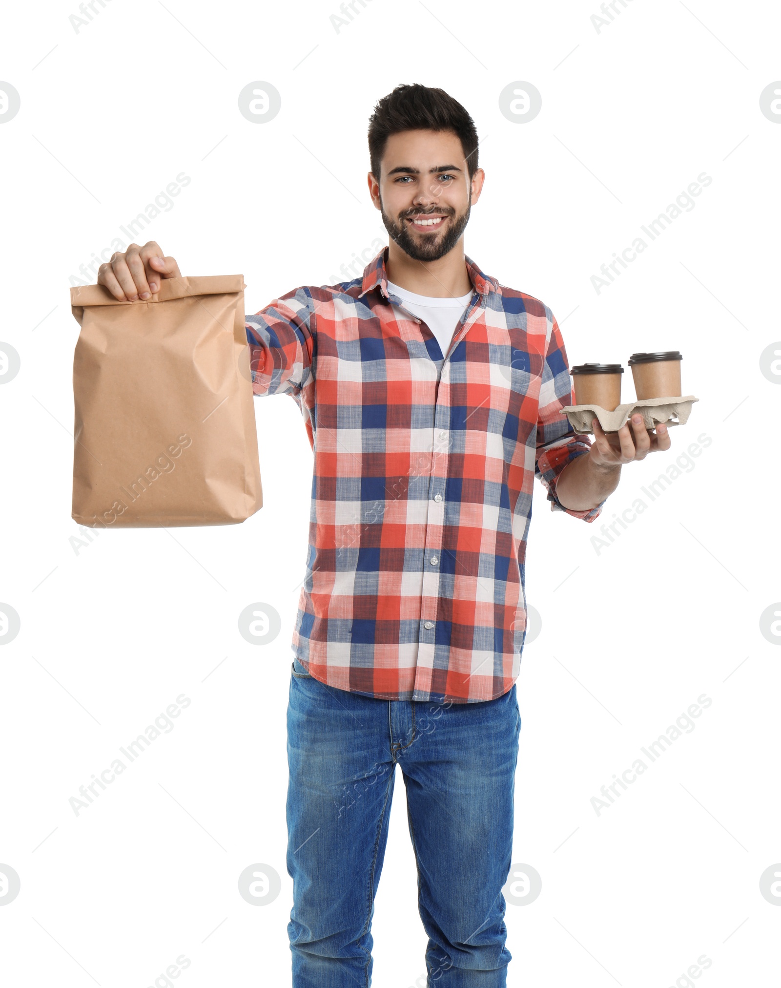 Photo of Young courier with paper bag and drinks on white background. Food delivery service