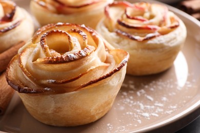 Freshly baked apple roses on plate, closeup. Beautiful dessert