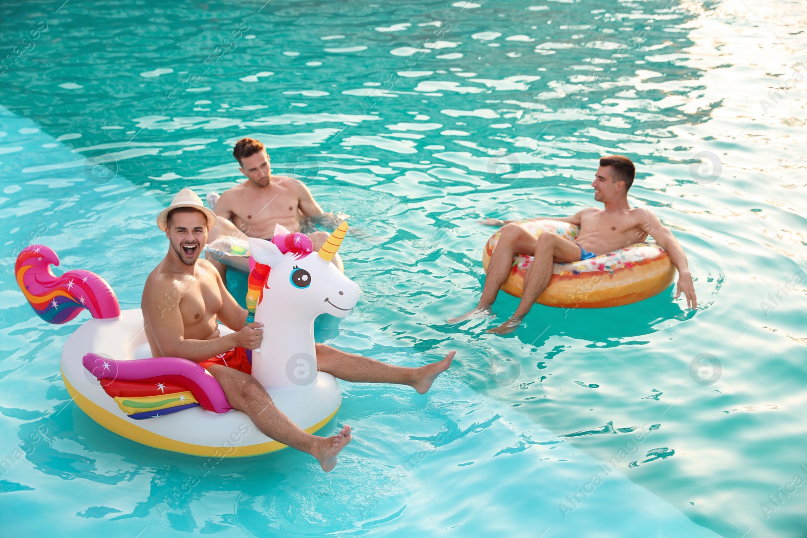 Photo of Happy young friends relaxing in swimming pool
