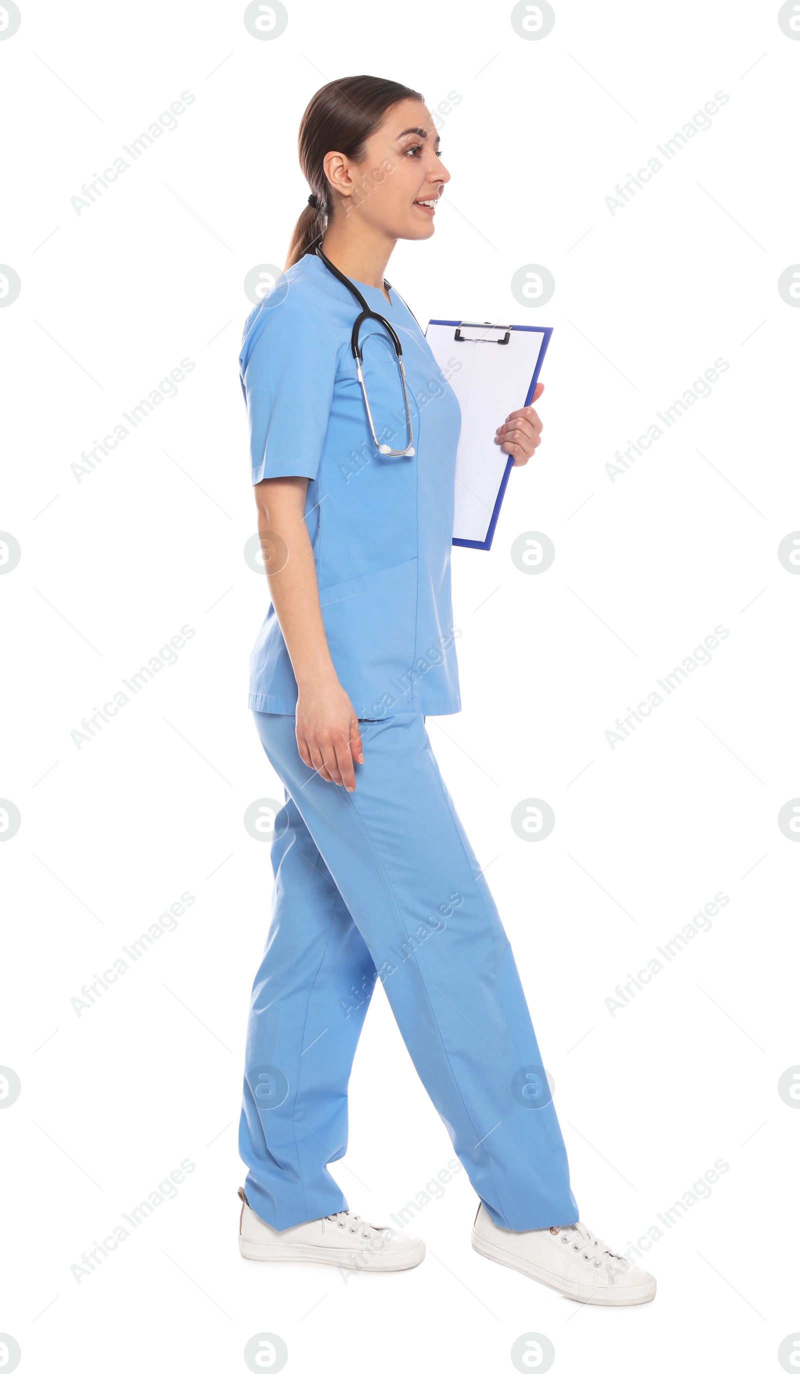 Photo of Full length portrait of medical doctor with clipboard and stethoscope isolated on white