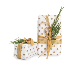 Christmas gift boxes decorated with fir branches on white background