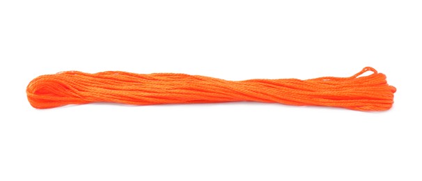 Bright orange embroidery thread on white background