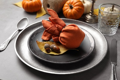 Photo of Seasonal table setting with pumpkins and other autumn decor on grey background