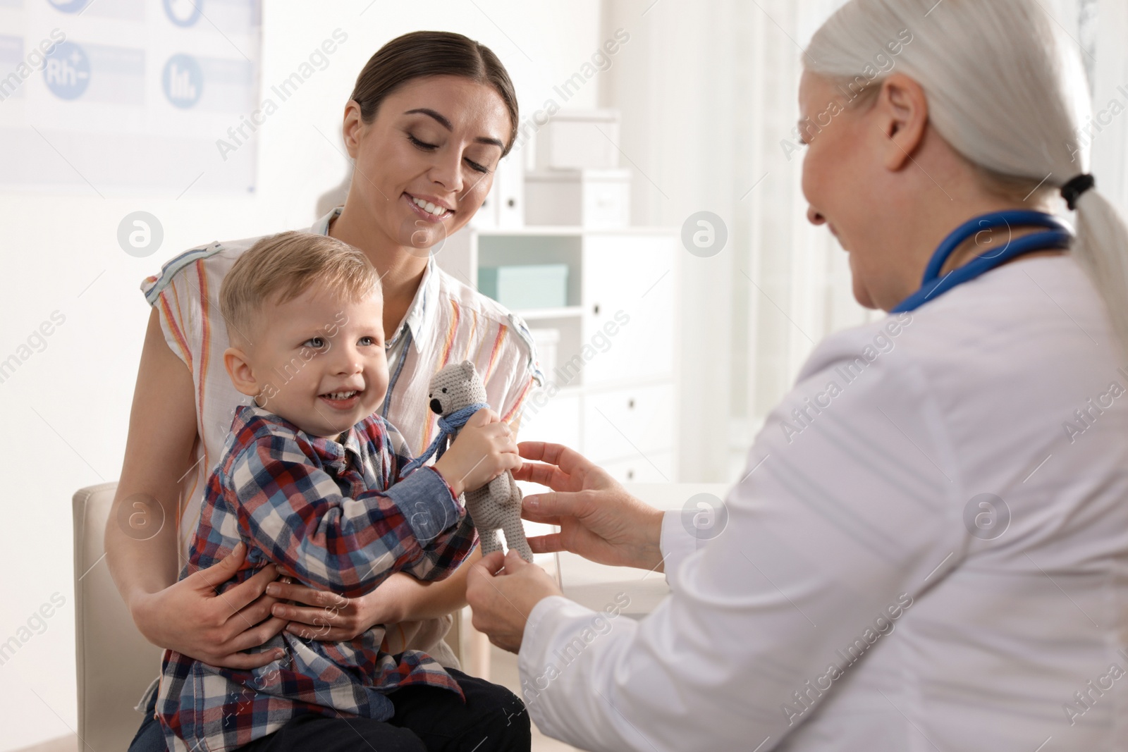 Photo of Mother with child visiting doctor in hospital