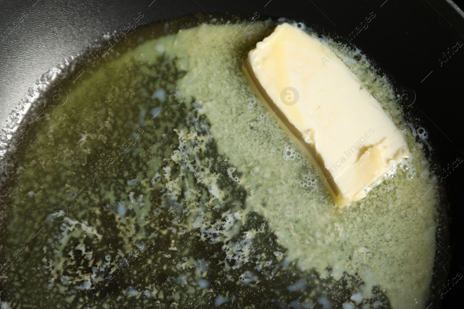 Photo of Melting butter in frying pan, top view