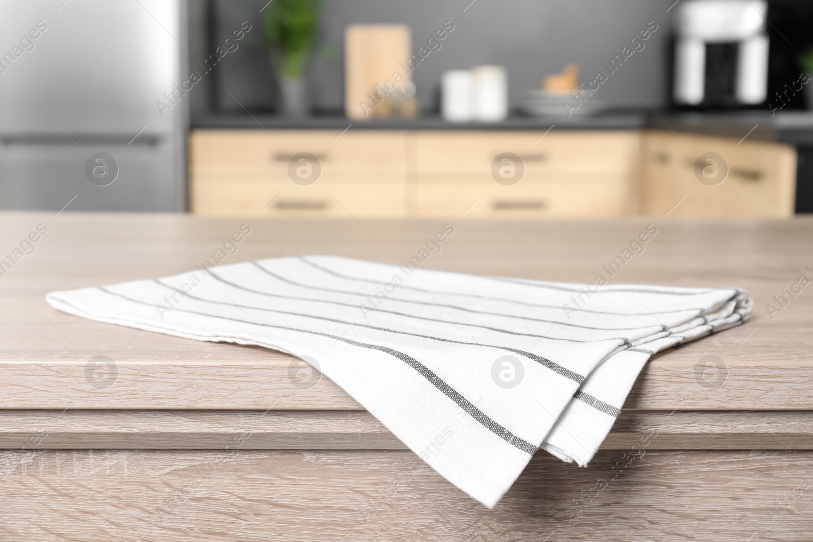 Photo of Napkin on wooden table in kitchen. Mockup for design