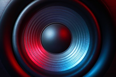 Photo of One sound speaker in neon light as background, closeup