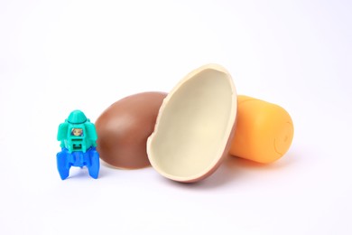 Slynchev Bryag, Bulgaria - May 24, 2023: Halves of Kinder Surprise Egg, plastic capsule and toy space rocket isolated on white