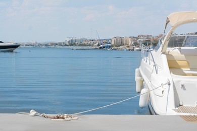 Photo of Beautiful view of city pier with moored boat on sunny day. Space for text