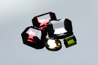 Photo of Beautiful gemstones for jewelry on light grey background