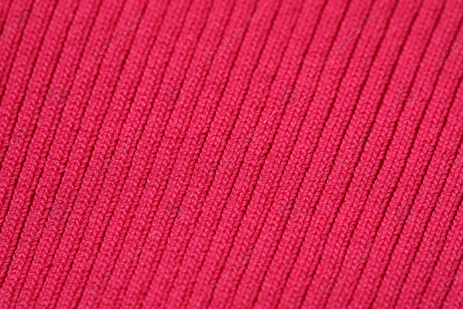 Photo of Texture of soft red knitted fabric as background, closeup