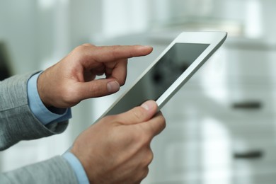 Closeup view of man using new tablet indoors