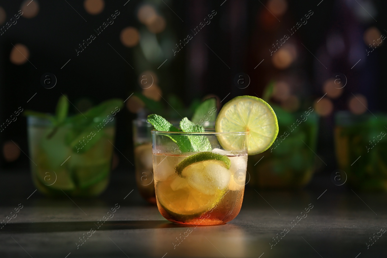 Photo of Glass with delicious mint julep cocktail on bar counter