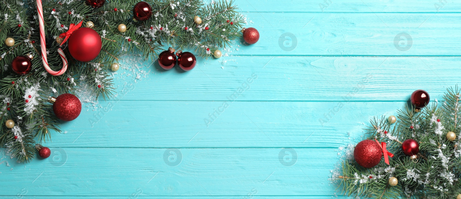 Photo of Fir tree branches with Christmas decoration on light blue wooden background, flat lay. Space for text