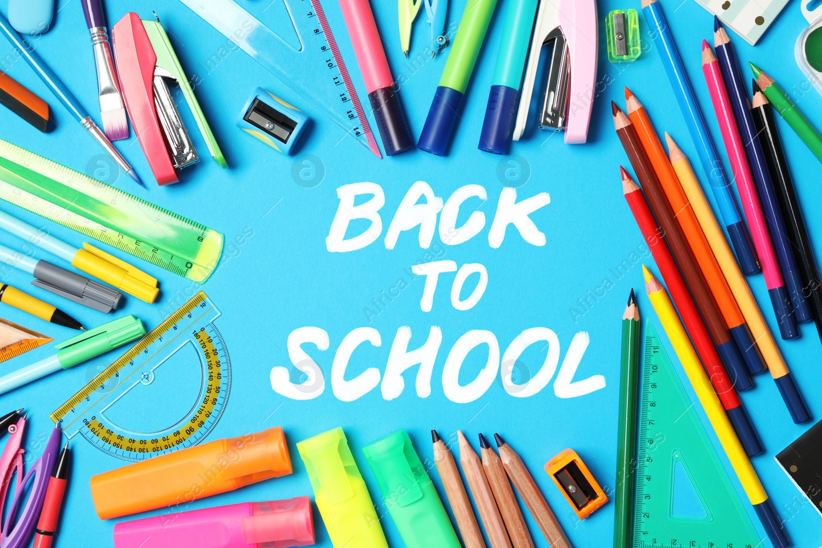 Image of Text Back To School and different stationery on blue background, flat lay