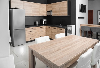 Photo of Cozy modern kitchen interior with new furniture and appliances