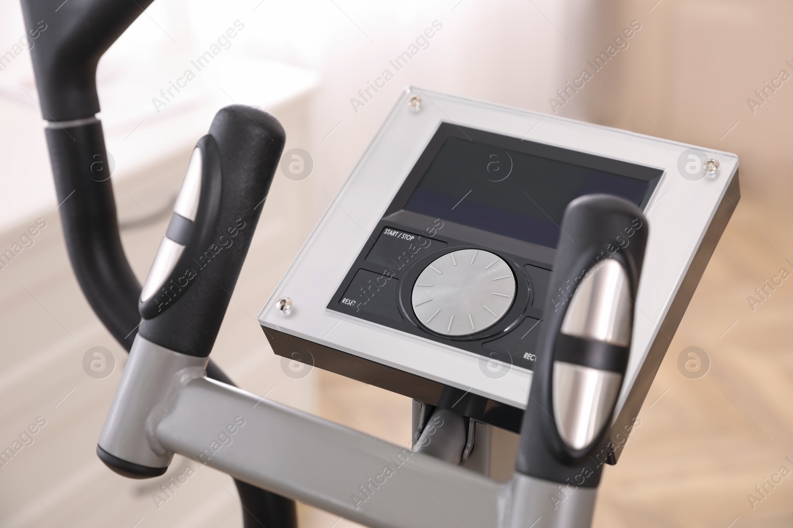 Photo of Control panel of modern elliptical machine cross trainer on blurred background, closeup