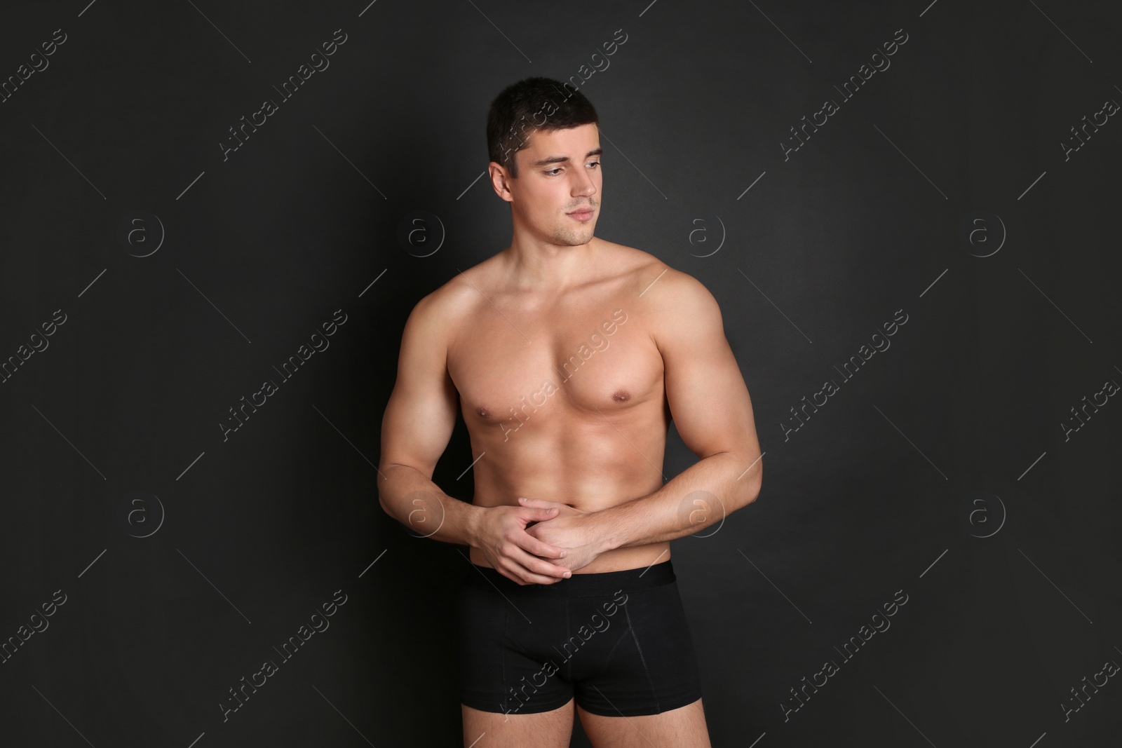 Photo of Man with sexy body on black background