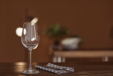 Photo of Empty wine glass on wooden table in restaurant