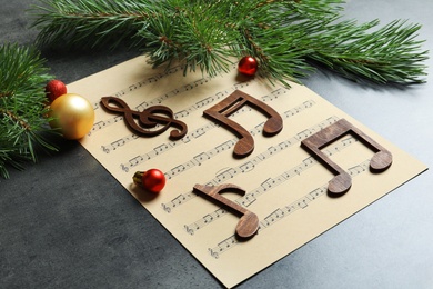 Photo of Composition with decoration and music sheet on table. Christmas songs concept