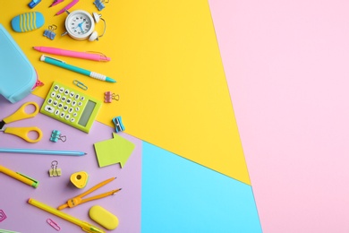 Photo of Different bright school stationery on color background, flat lay. Space for text