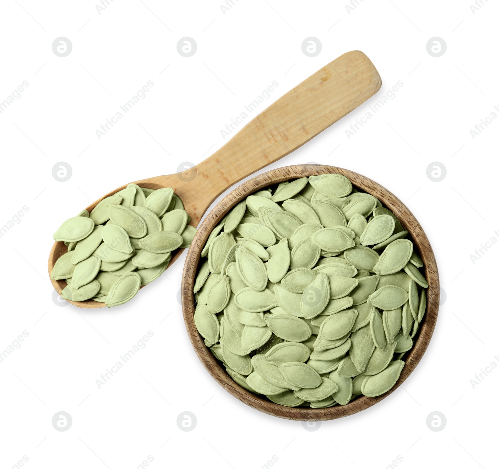 Photo of Wooden bowl and spoon with pumpkin seeds isolated on white, top view
