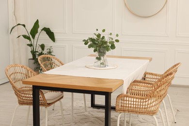 Stylish dining room with cozy furniture and plants