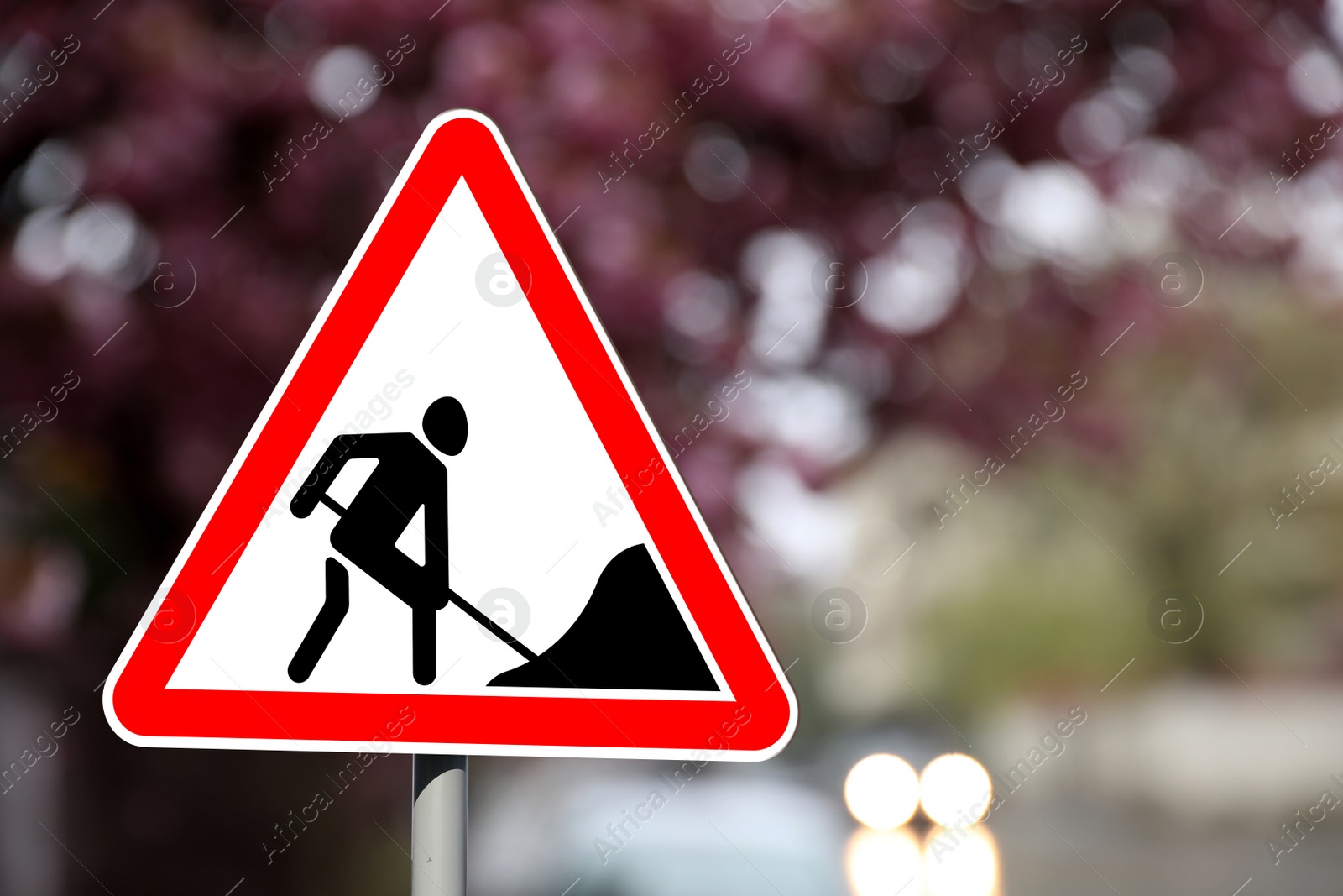 Image of Traffic sign Road Works on city street. Bokeh effect
