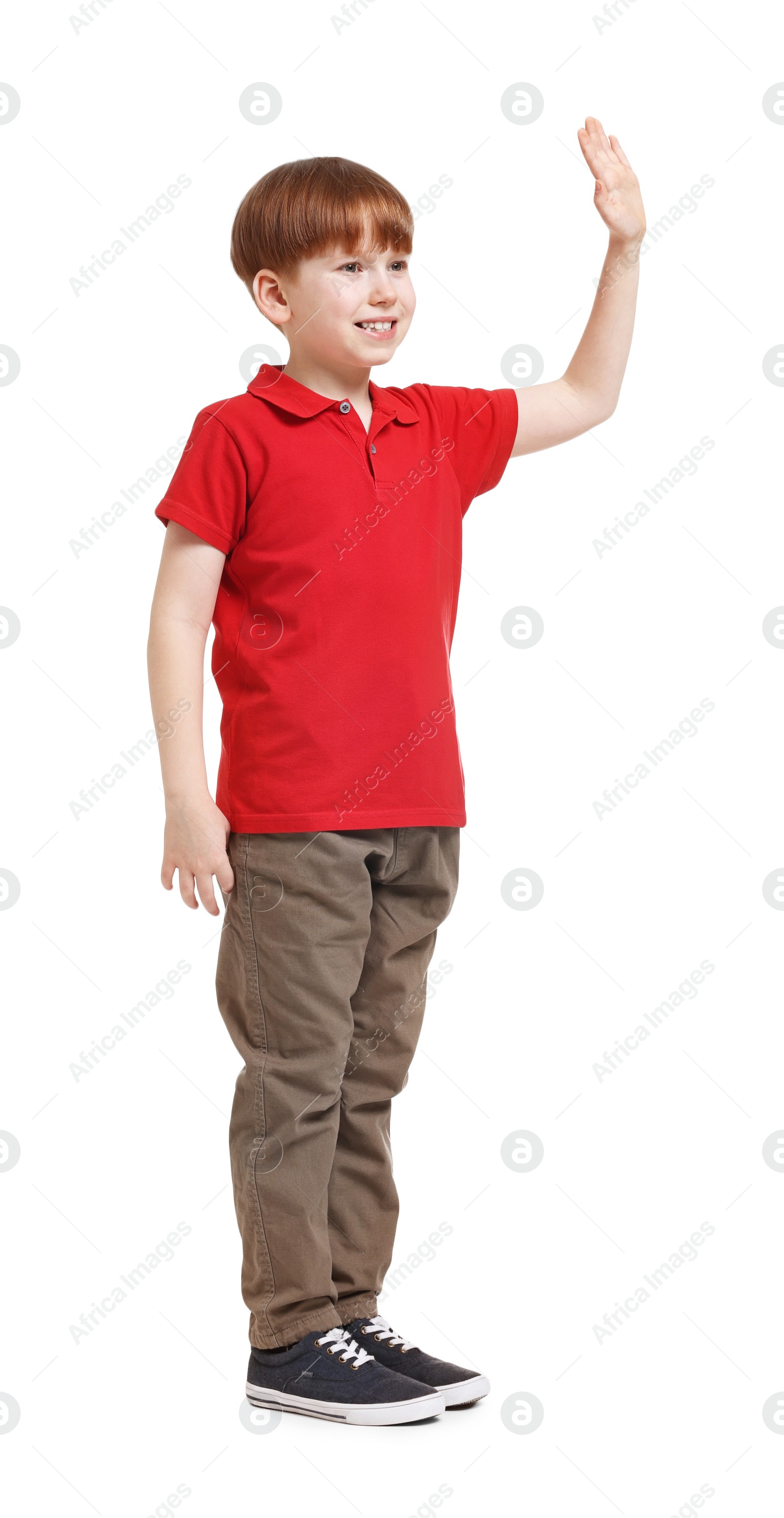Photo of Smiling little boy waving hand on white background