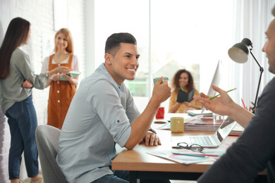 Photo of Team of professional designers working in office