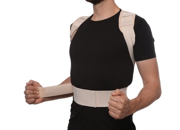 Closeup view of man with orthopedic corset on white background