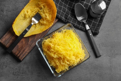 Photo of Flat lay composition with cooked spaghetti squash on grey table