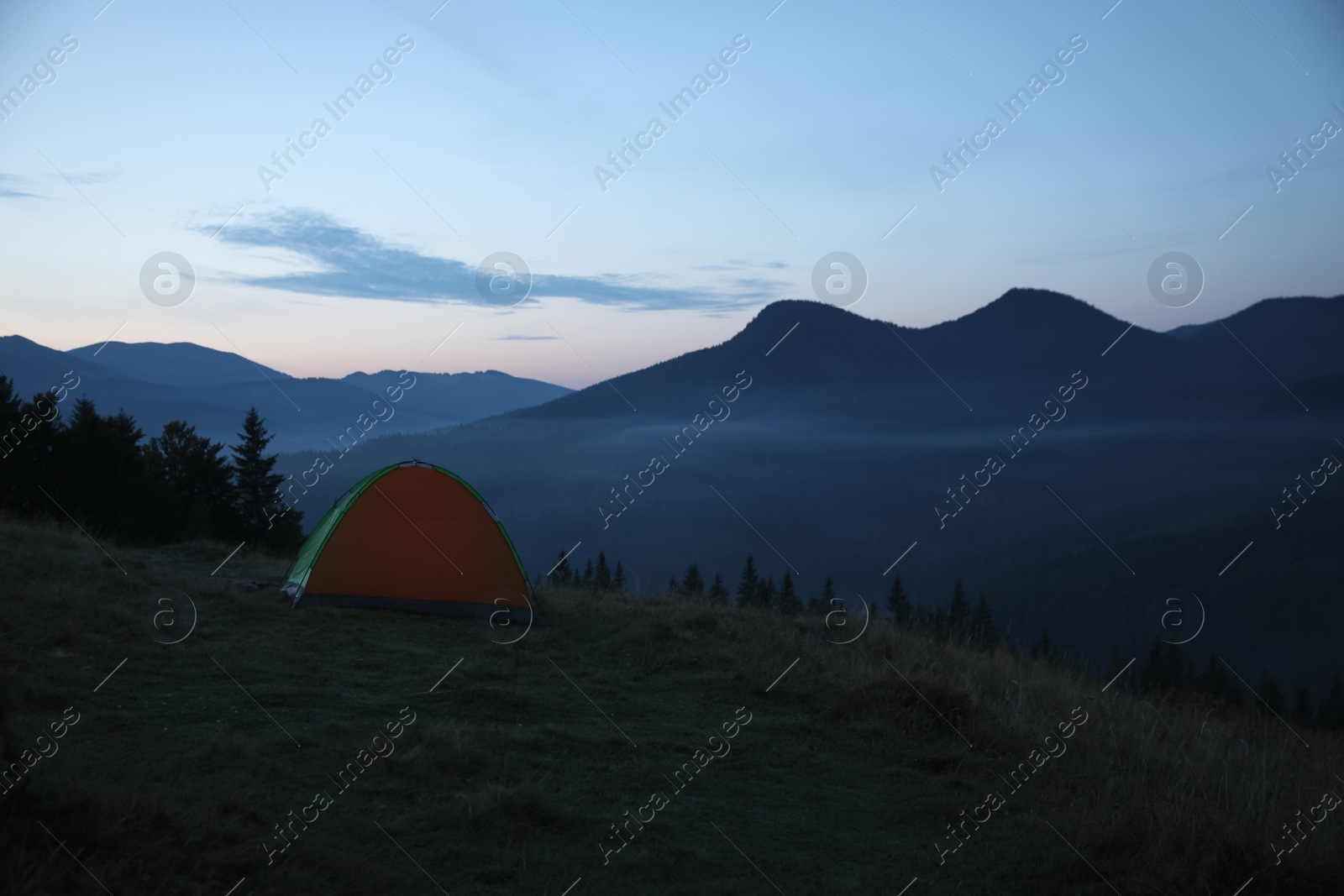 Photo of Camping tent on mountain slope in morning