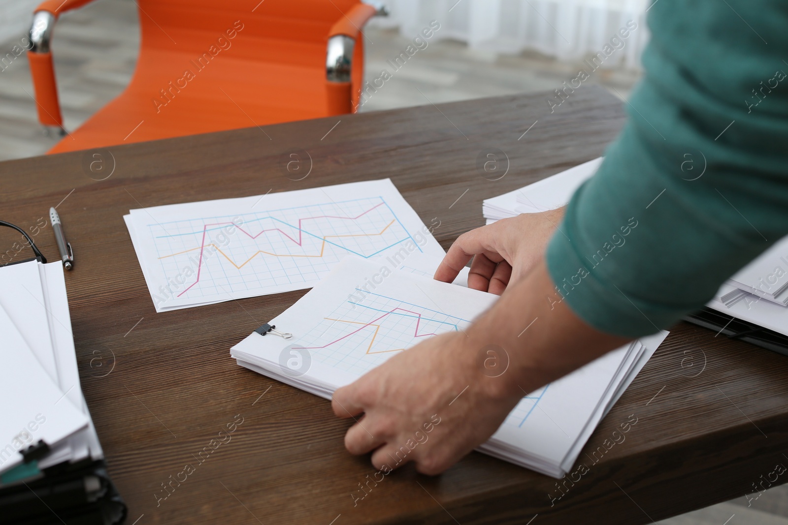 Photo of Businessman working with documents at office table, closeup