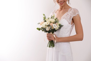 Photo of Young bride with beautiful wedding bouquet on white background, closeup. Space for text