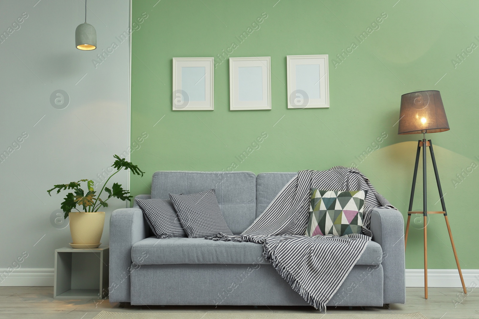 Photo of Stylish room interior with cozy sofa